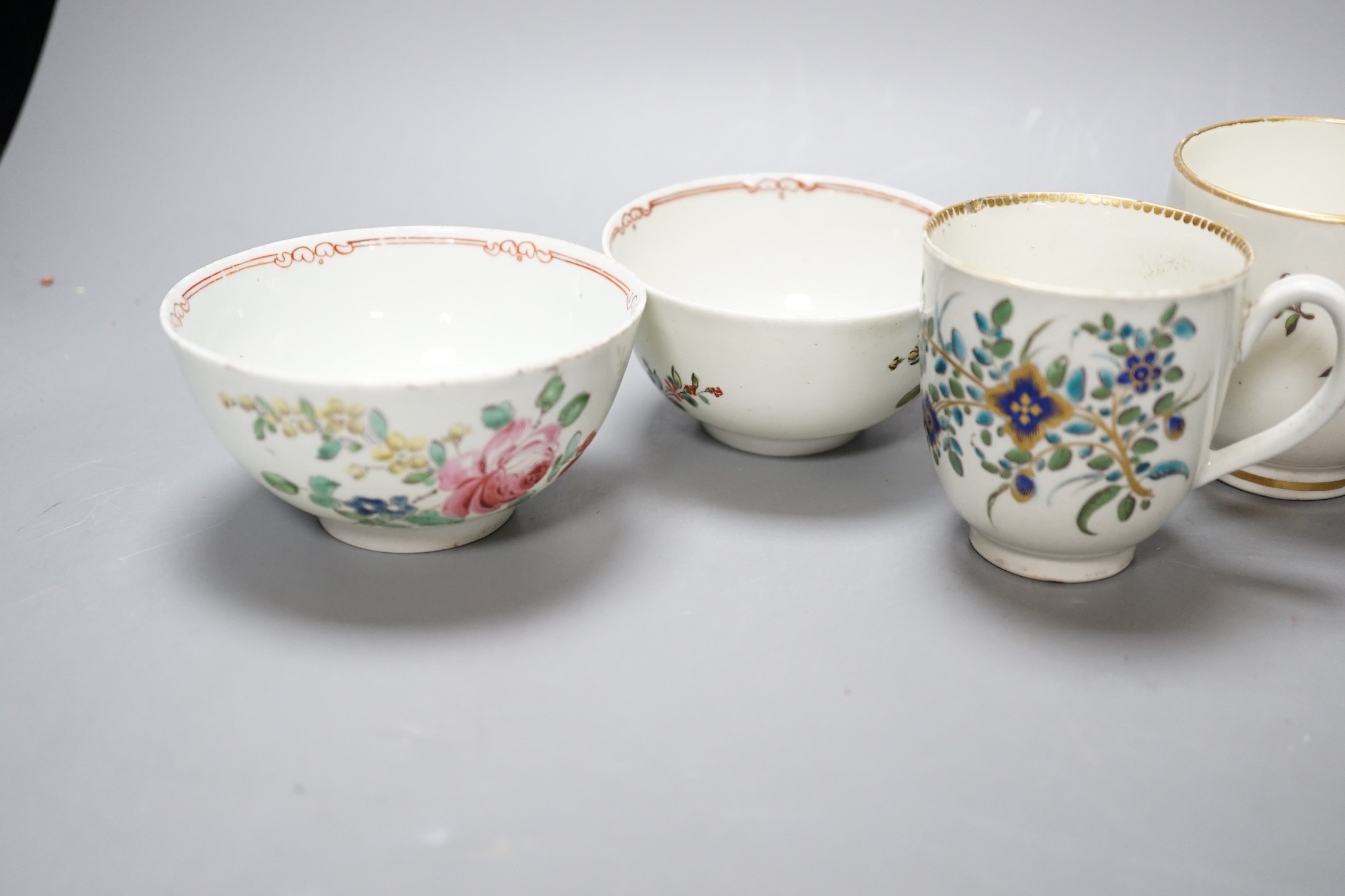 A Worcester coffee cup with oriental figures, another with flowers in green blue and gold, two Chelsea Derby coffee cups and two Christian Liverpool tea bowl with roses, largest bowl 9 cms diameter